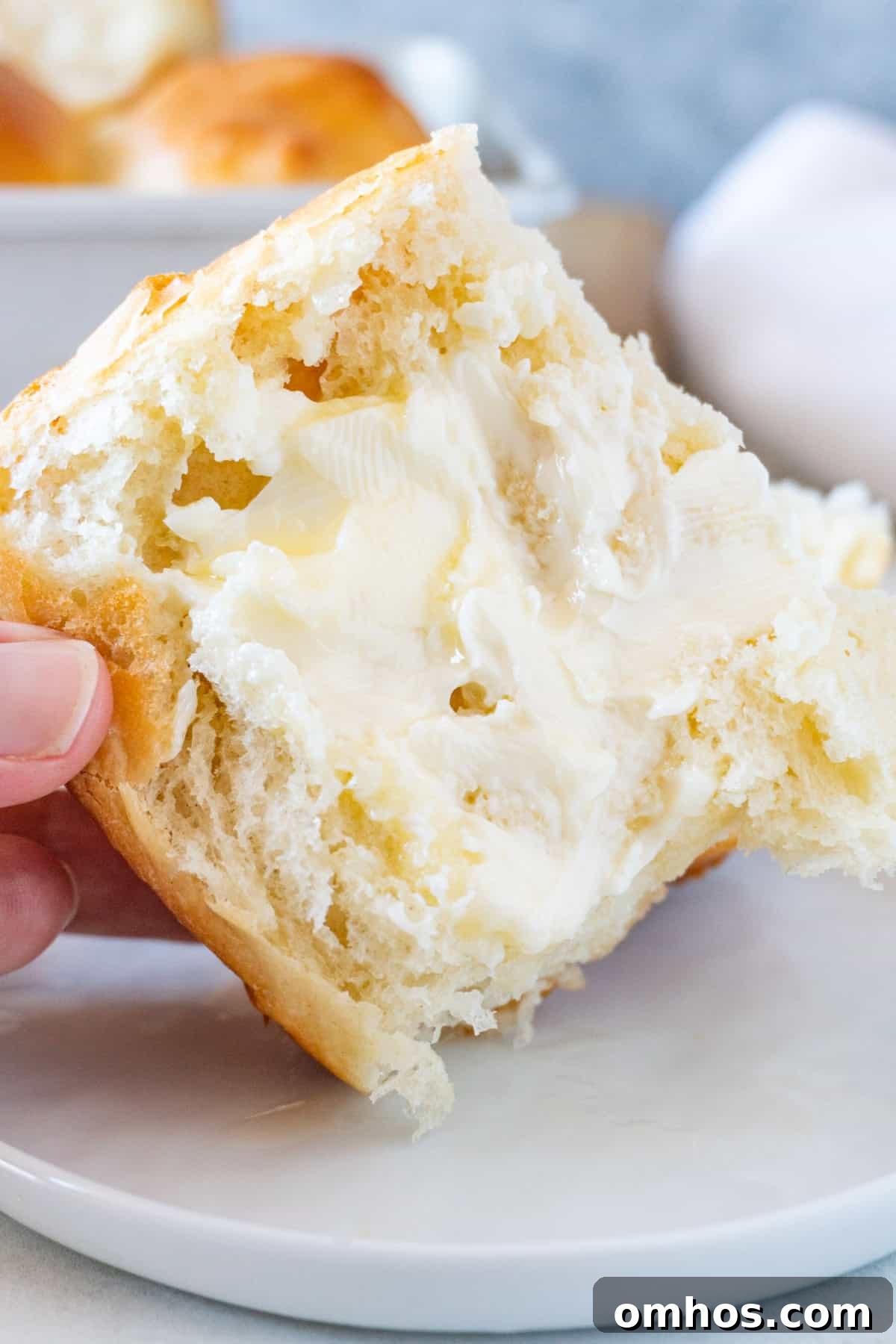 Fluffy Soft Dinner Rolls: Buttery Homemade Recipe 16 half a soft dinner roll with butter spread on.