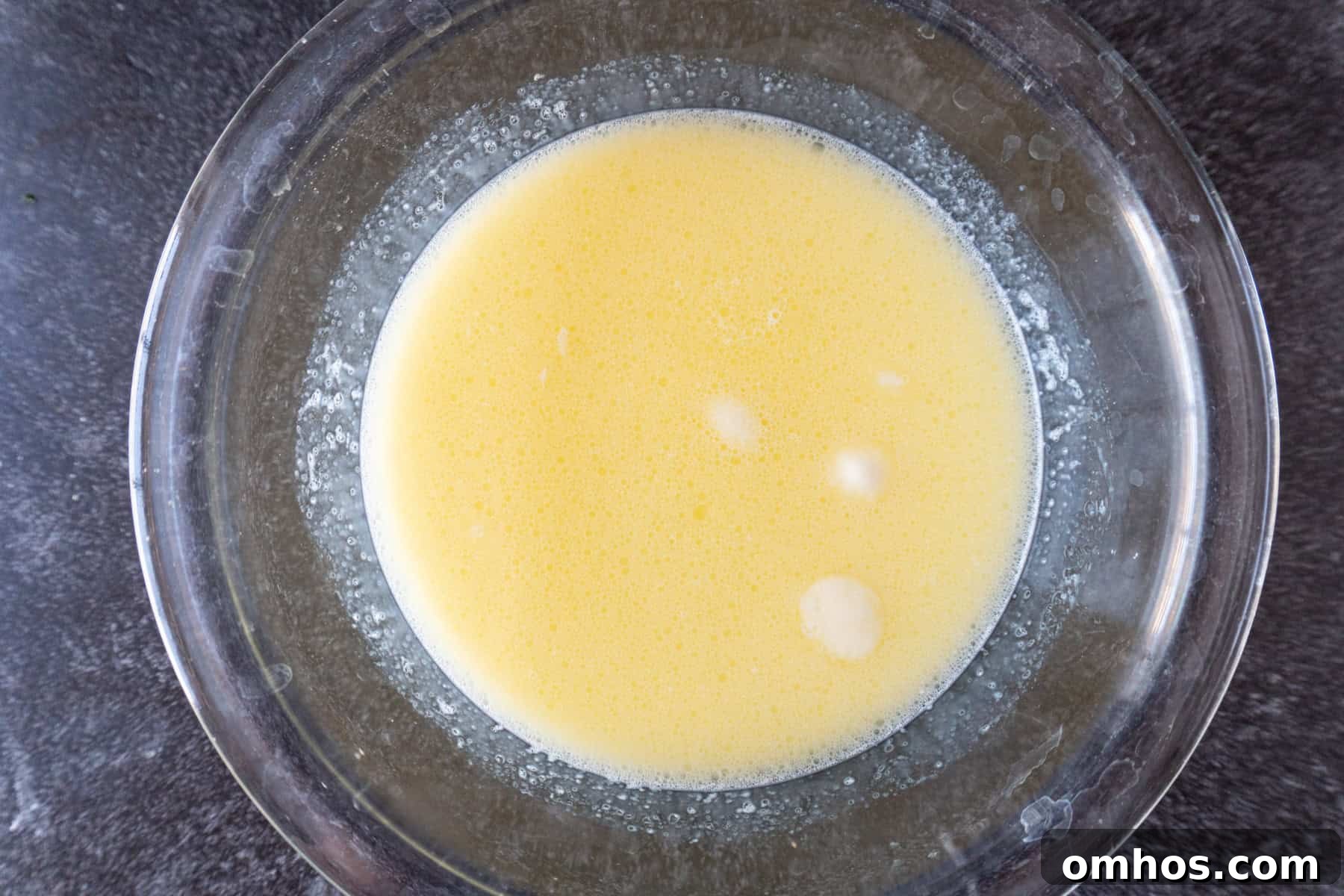 Fluffy Soft Dinner Rolls: Buttery Homemade Recipe 7 milk and butter mixed together in glass bowl.