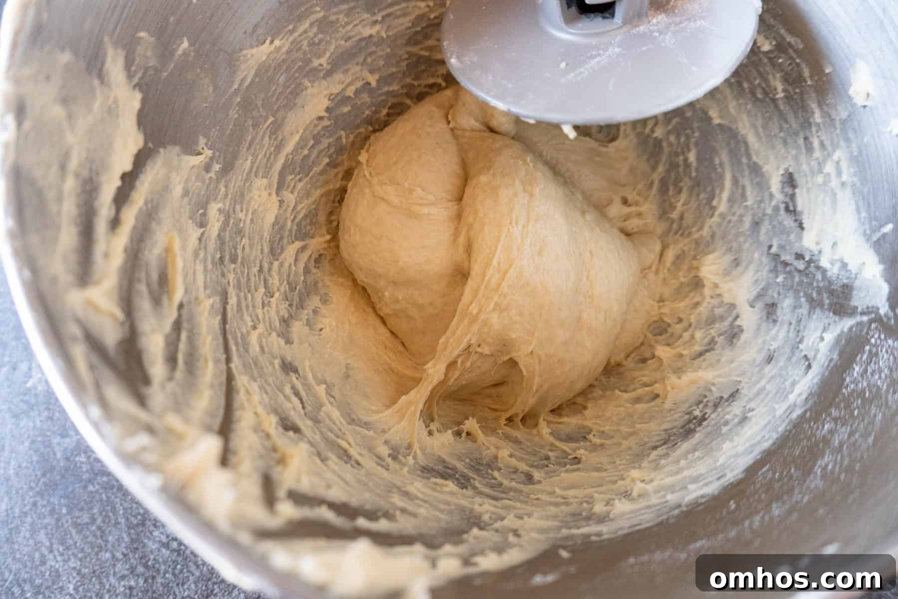 Fluffy Soft Dinner Rolls: Buttery Homemade Recipe 8 bread dough kneaded in mixing bowl.