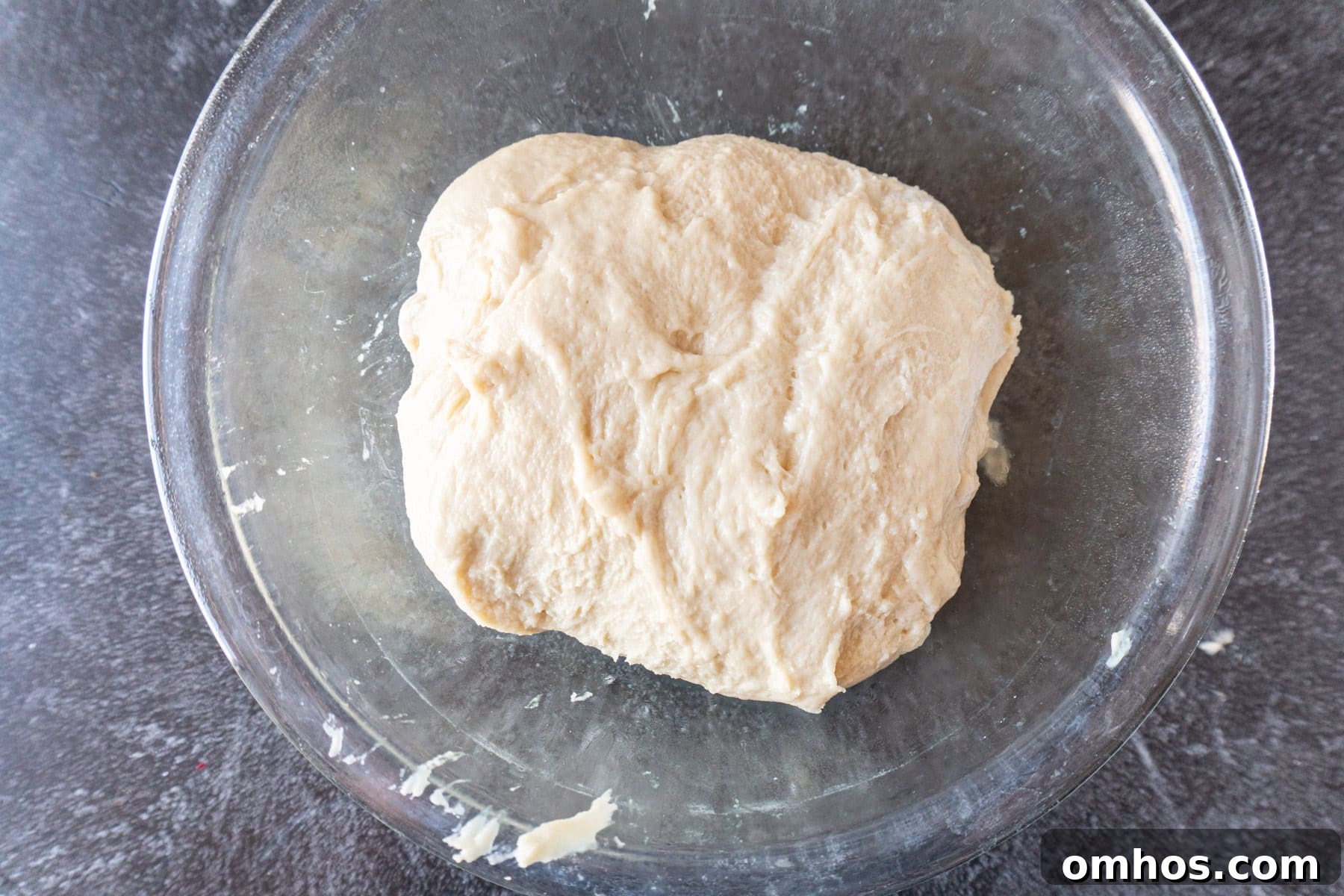Fluffy Soft Dinner Rolls: Buttery Homemade Recipe 9 bread dough in clean glass bowl before first rise.