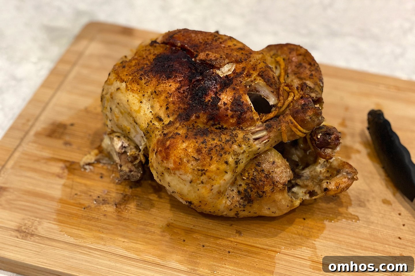 A whole Air Fried Chicken on a cutting board