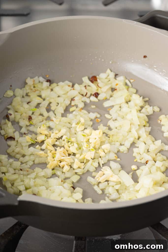 Turmeric Basmati Rice Recipe: Light and Fluffy 3 garlic, onions, and peppers in a pan