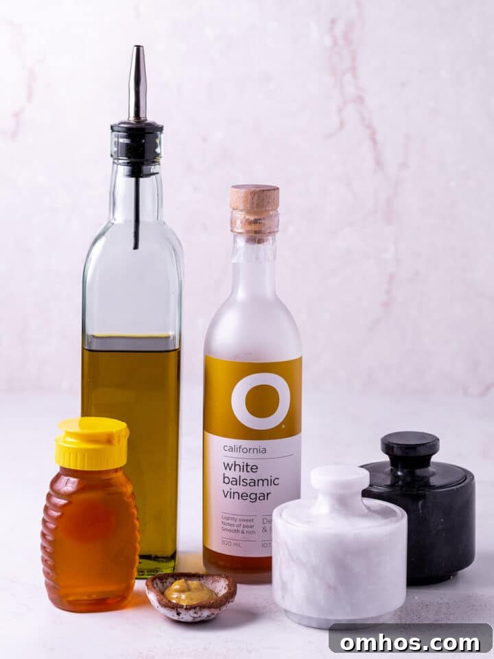 picture of extra virgin oliveoil, white balsamic vinegar, honey, dijon mustard, salt and pepper- ingredients needed to make white balsamic vinaigrette
