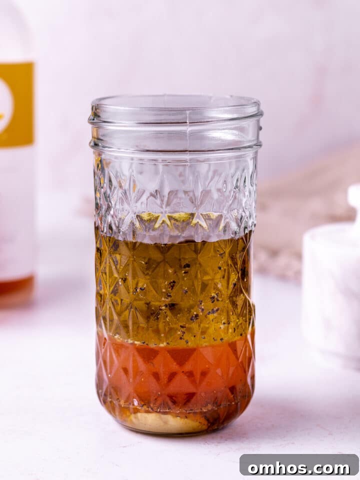 mason jar with unmixed salad dressing ingredients