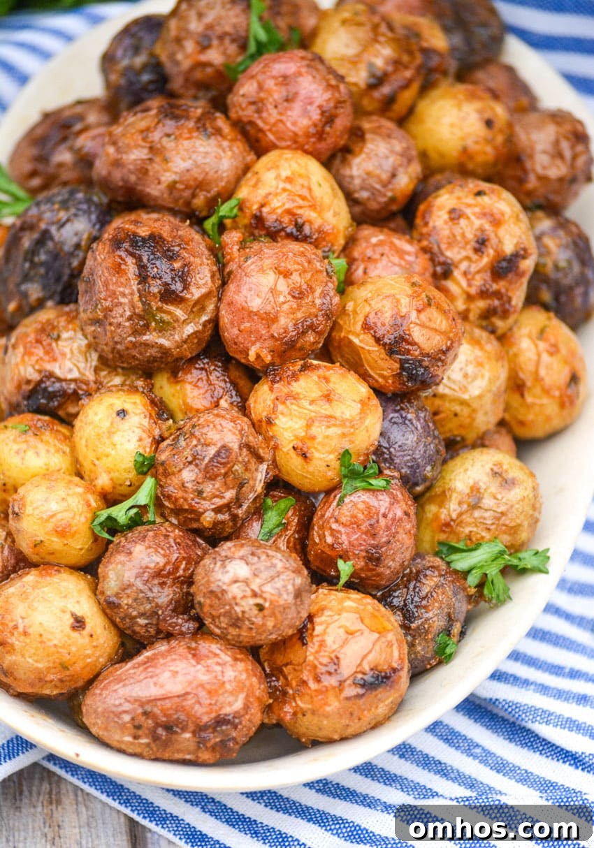 Crispy Roasted Potatoes with Mayonnaise 2 mayonnaise roasted potatoes topped with fresh parsley leaves on an oval serving platter