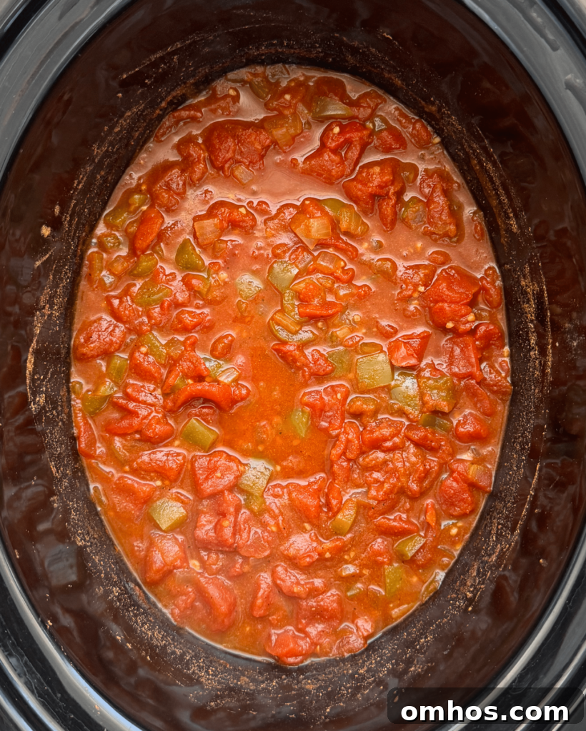 overhead shot of cooked slow cooker shakshuka in a black slow cooker