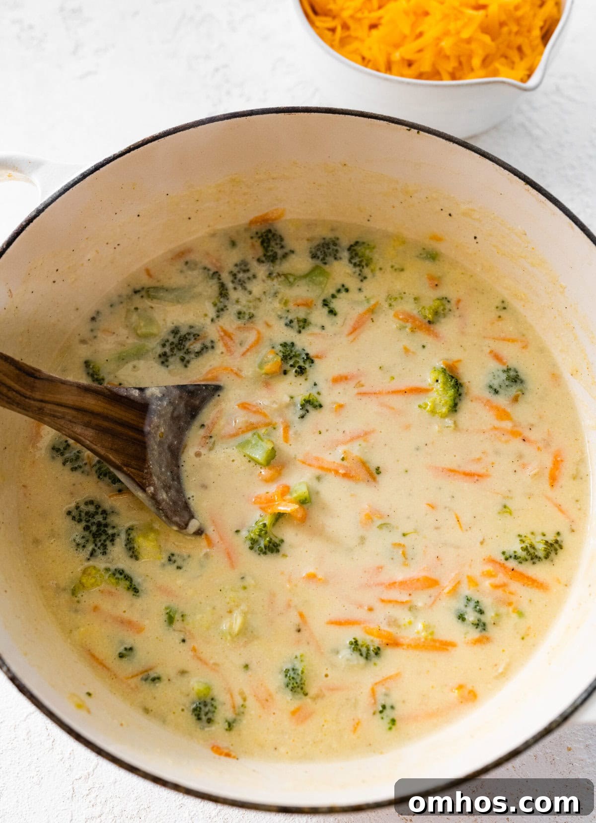 How to Make Copycat Panera Broccoli Cheddar Soup step-by-step: mash broccoli slight.ly with a wooden spoon.