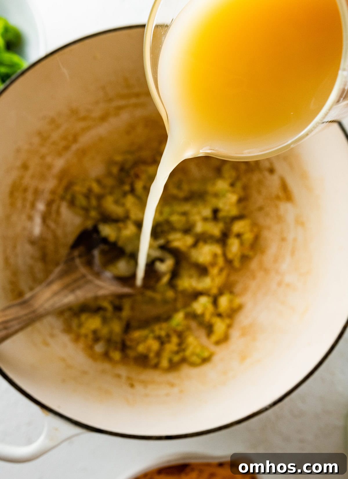 How to Make Copycat Panera Broccoli Cheddar Soup step-by-step: add the broth and thicken the soup base.