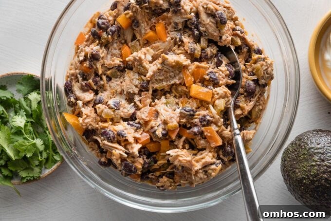 Crispy Baked Chicken and Black Bean Taquitos 6 Filling for chicken black bean taquitos mixed together in a prep bowl.