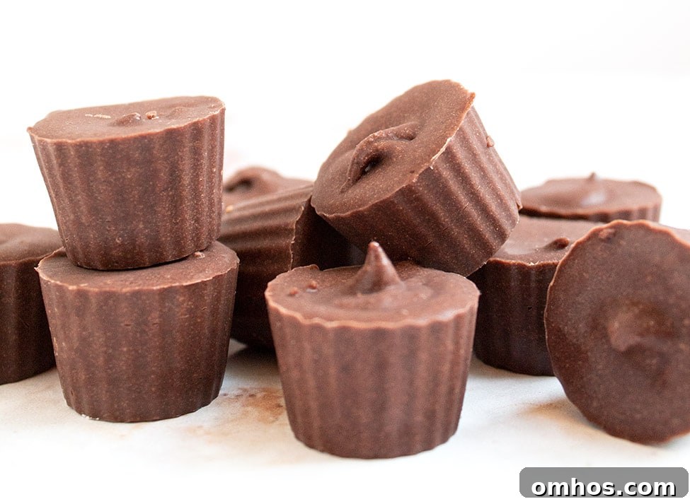 chocolate fat bombs stacked up on top of each other with white background