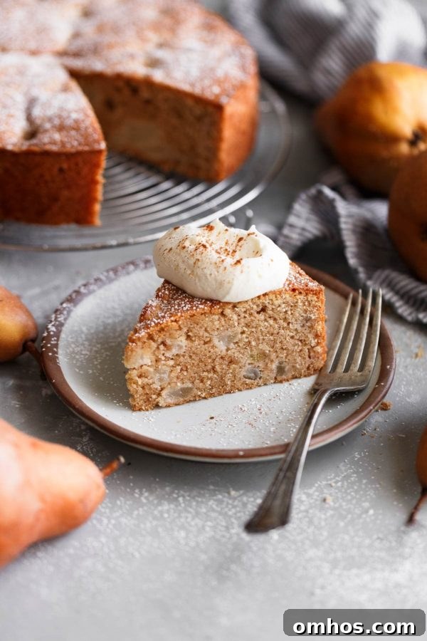 Spiced Almond Pear Cake topped with lightly sweetened whipped cream