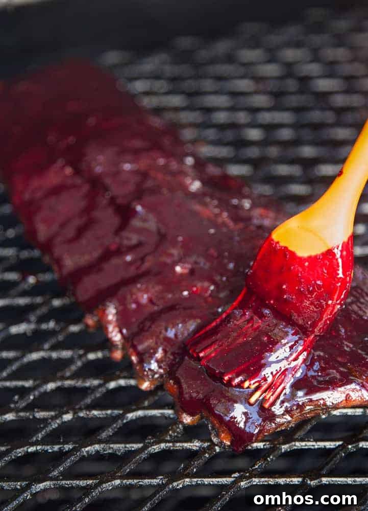 Applying Blueberry Bourbon Rosemary BBQ Sauce to Smoked Ribs