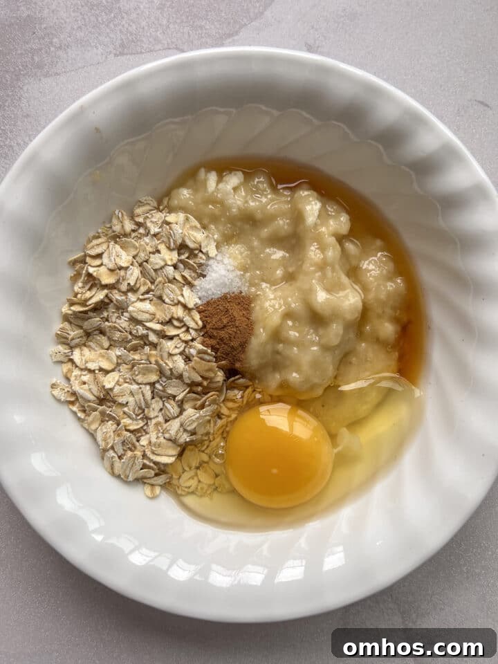 Ingredients for scrambled oats in a small white bowl, unmixed.