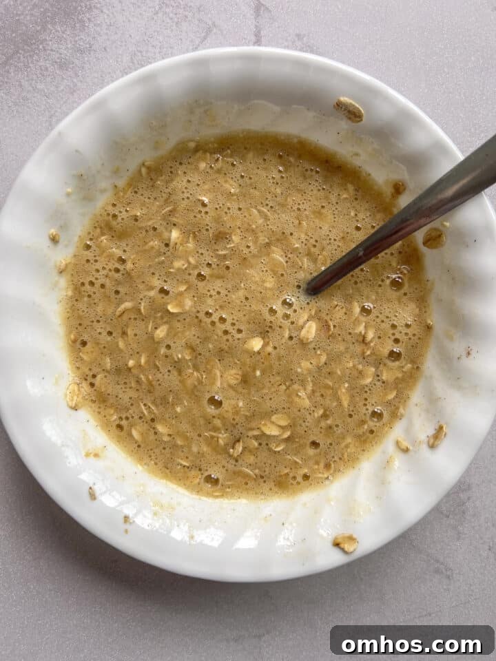 Mixture for scrambled oats resting in a white bowl.
