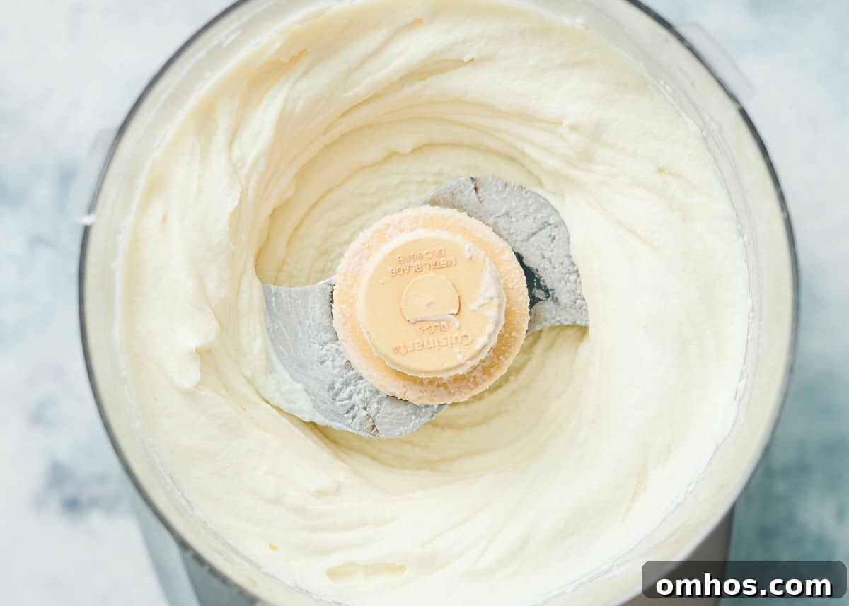 Creamy Whipped Ricotta Dip with Honey 5 Creamy whipped ricotta in a food processor.