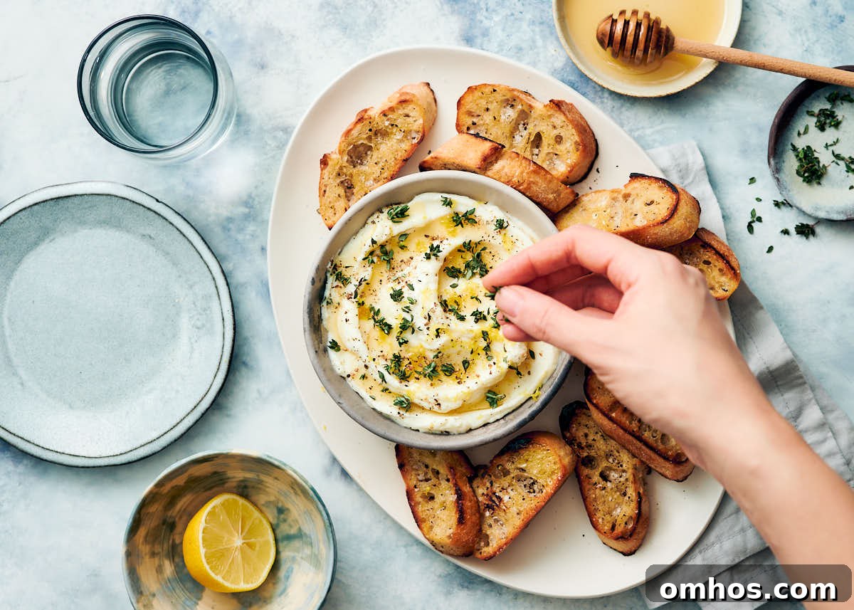 Creamy Whipped Ricotta Dip with Honey 6 Garnishing fluffy whipped ricotta with honey and fresh thyme.