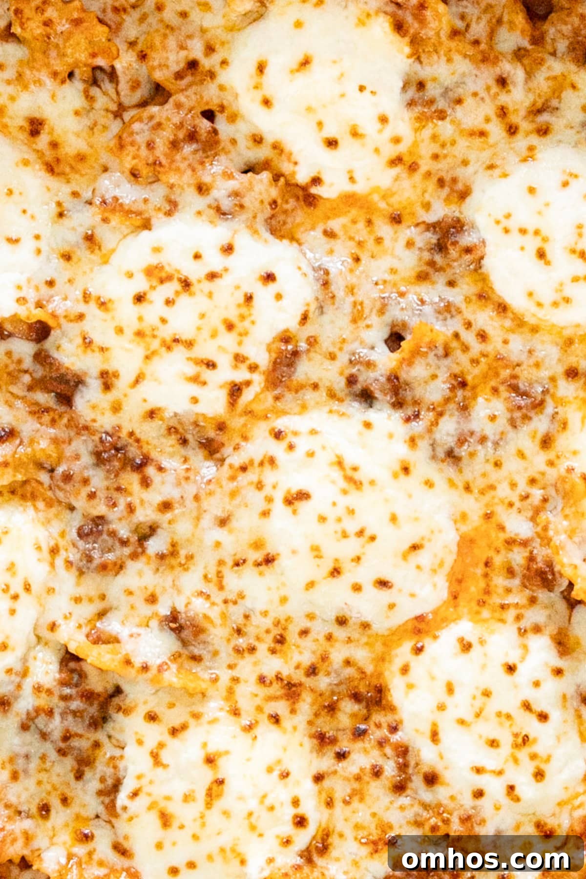 A close up overhead image of the top of the pasta covered in melty cheese.