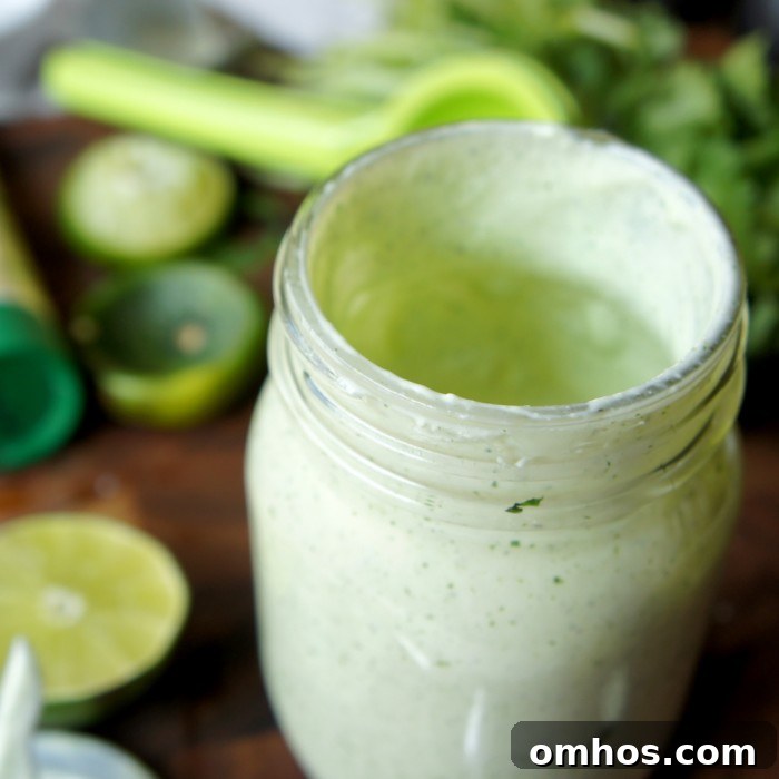 Close up of green salad dressing in a mason jar