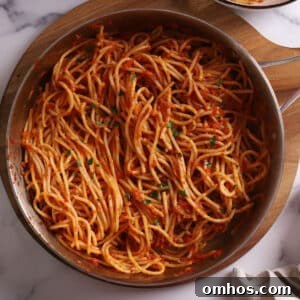 An overhead image of a large skillet with harissa pasta.