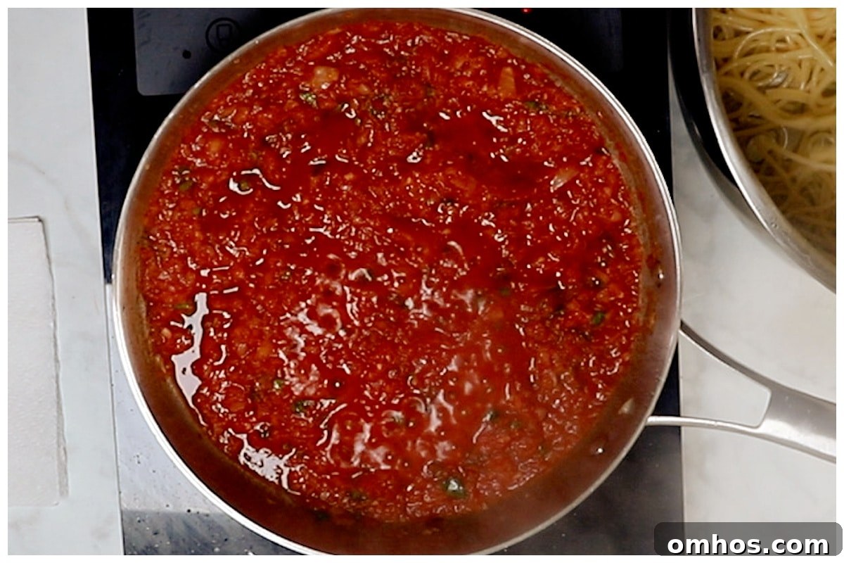 Tomato harissa sauce cooked in a skillet.