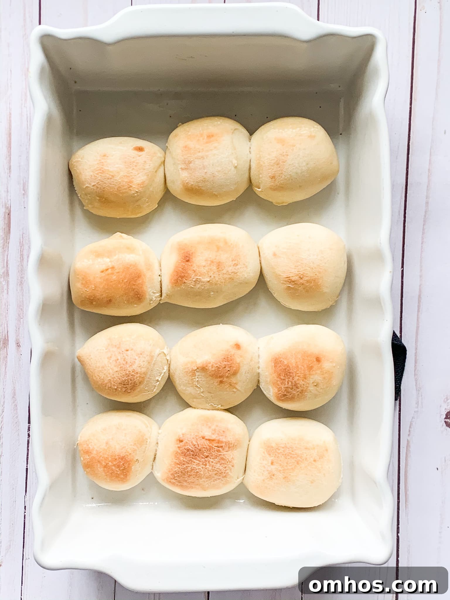 Baked Parker House rolls in a baking dish.