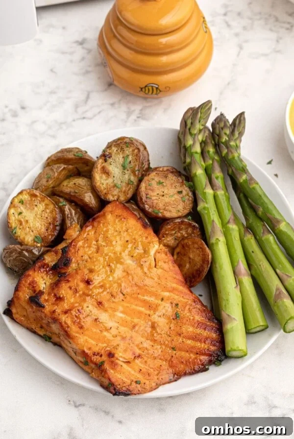 Crispy Air Fryer BBQ Ribs Recipe with Sticky Glaze 10 Cooked honey mustard glazed salmon served on a white plate with asparagus.