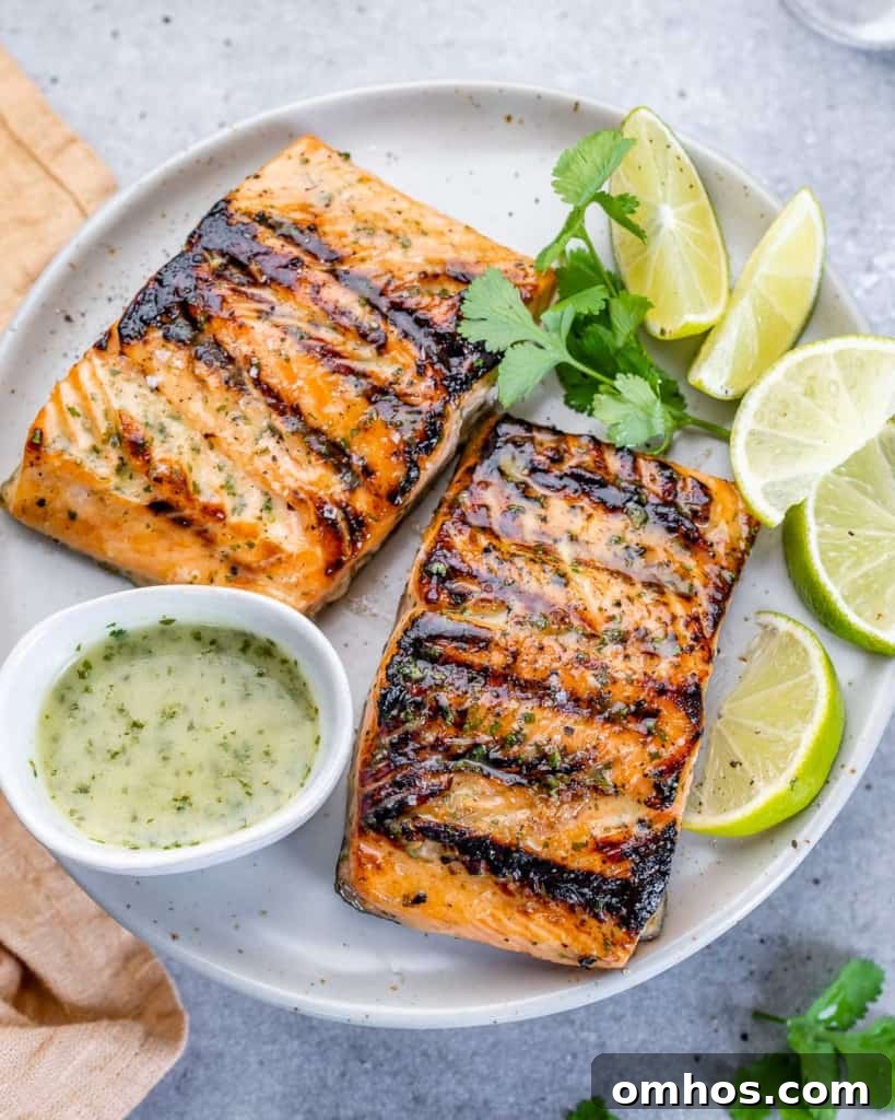 top view of 2 grilled salmon filets on a white plate