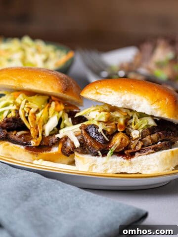 Two braised beef sliders topped with citrus slaw.