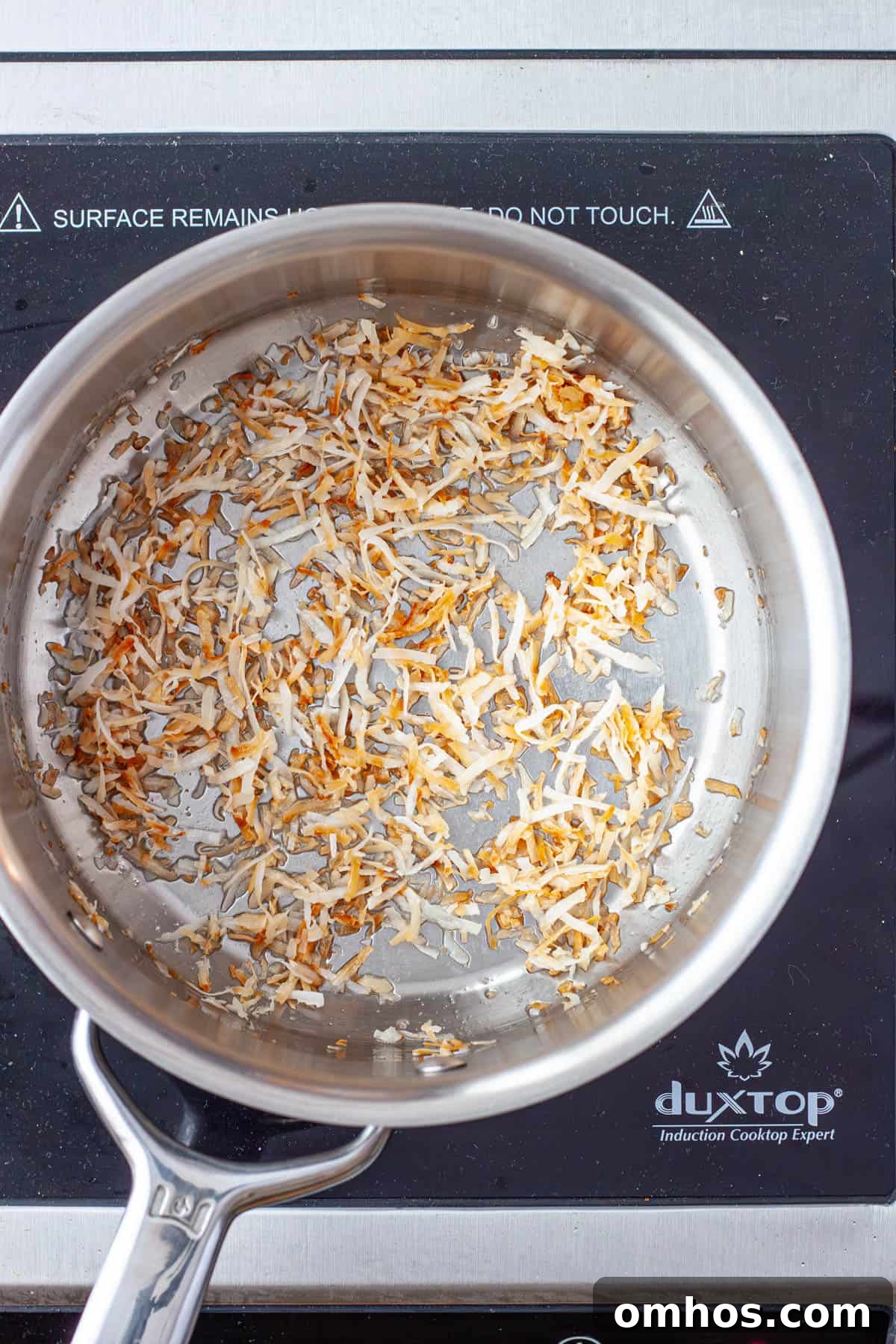 Fragrant Coconut Cilantro Rice Recipe 4 Shredded coconut toasting in a medium saucepan.
