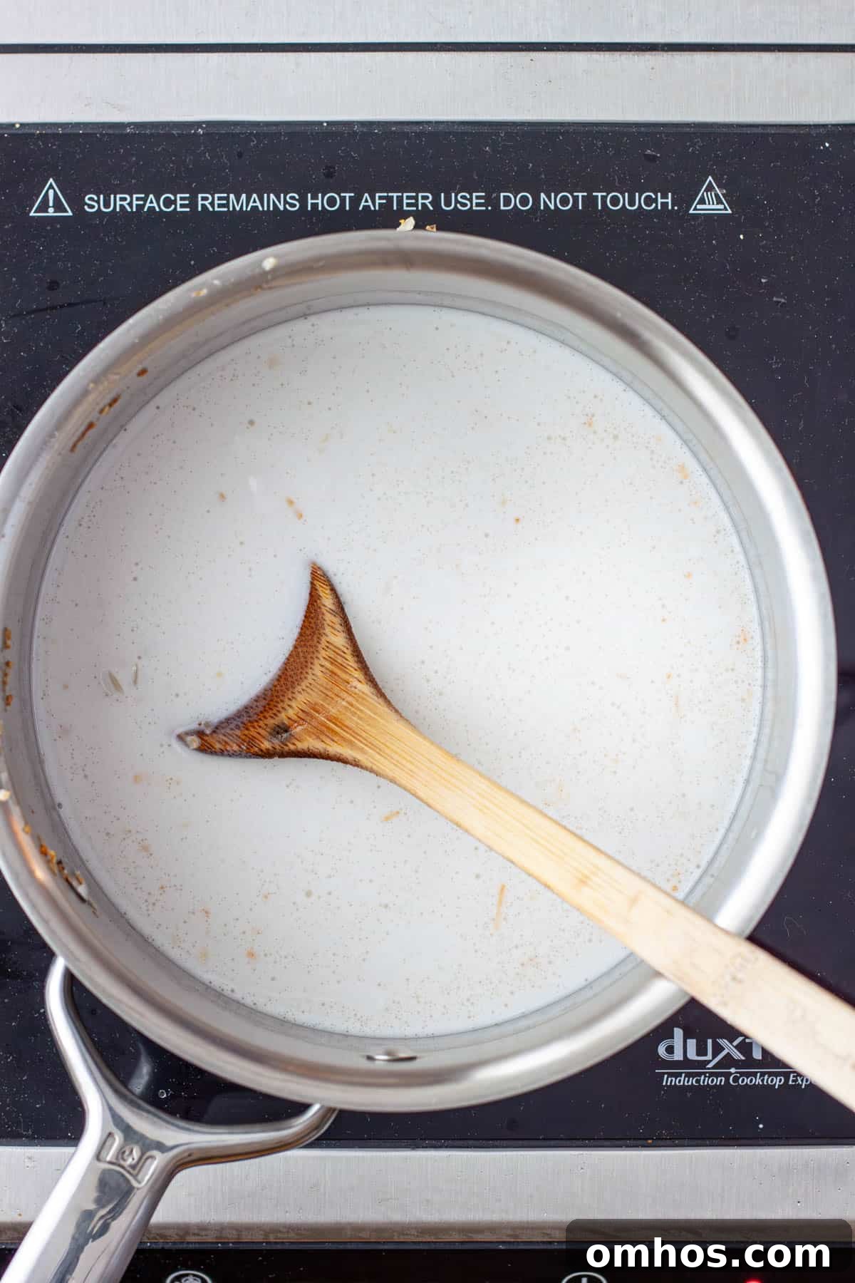 Fragrant Coconut Cilantro Rice Recipe 6 Coconut milk and water in a saucepan with rice.