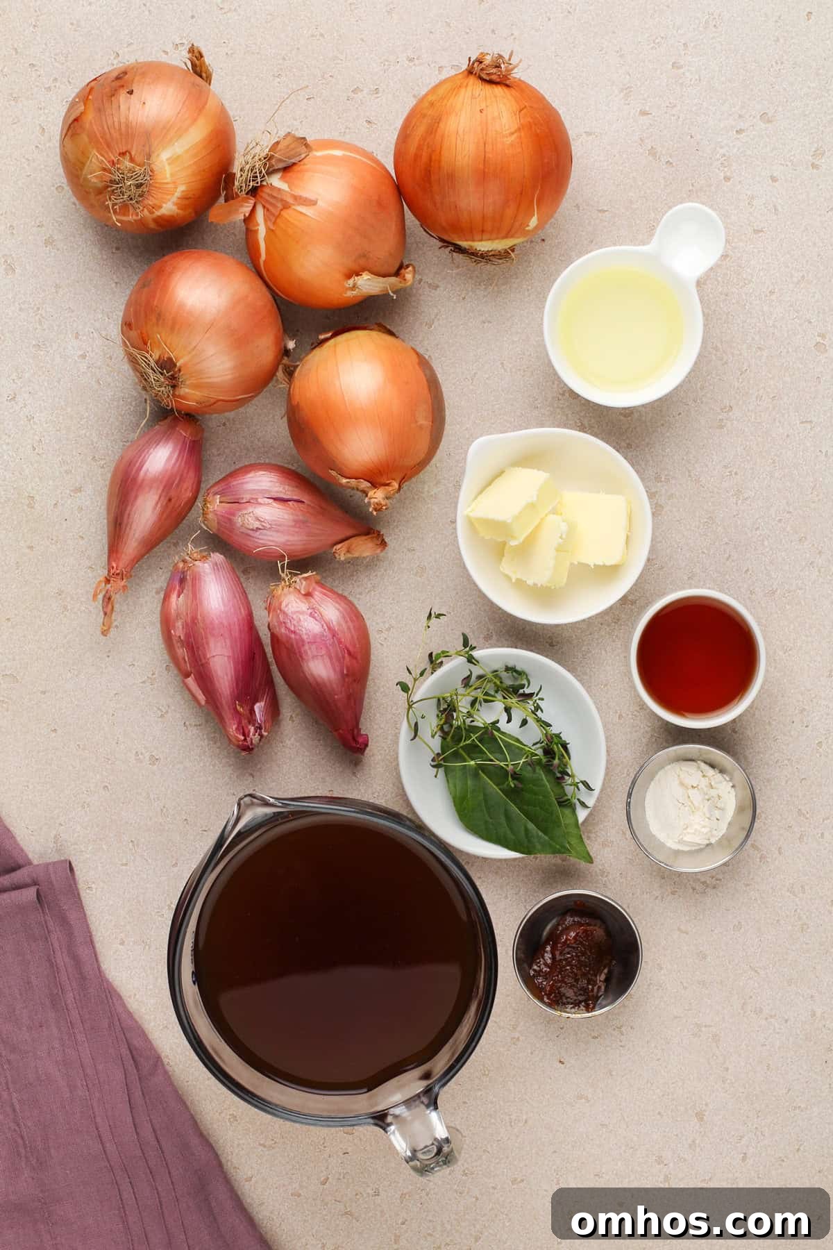 Ingredients for french onion soup arranged on a countertop.