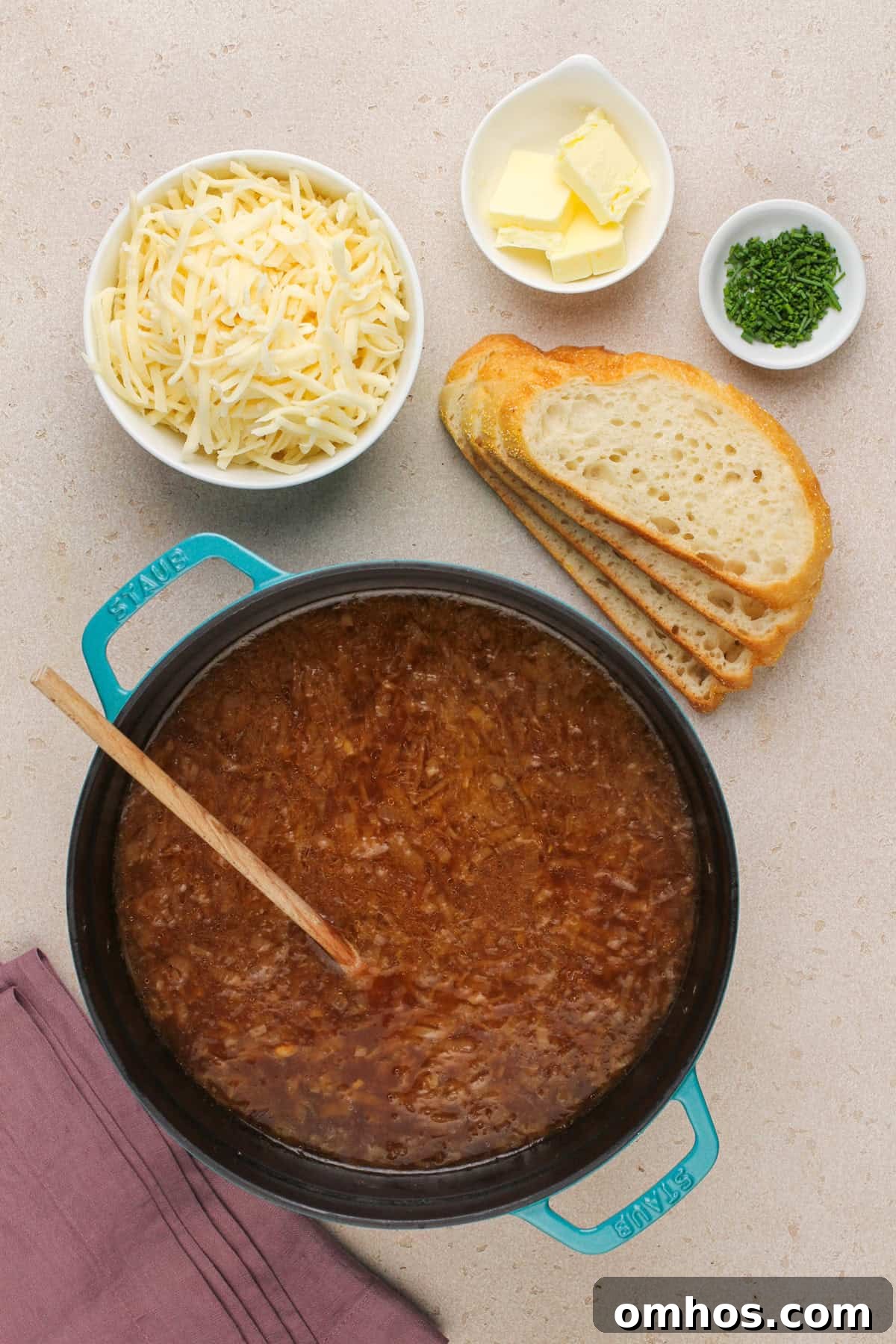 Ingredients for assembling and serving french onion soup arranged on a countertop.