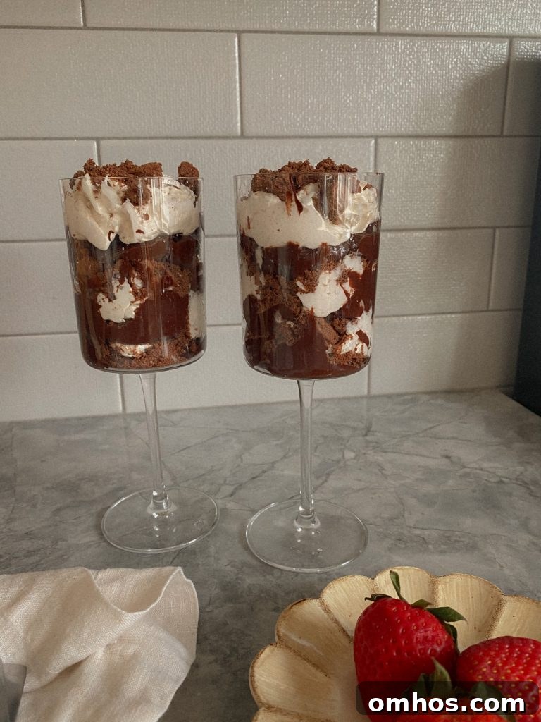 Creamy Vegan and Paleo Chocolate Pudding Recipe 2 Vegan and Paleo Avocado Chocolate Pudding layered in a Wine Glass with coconut cool whip and gluten-free chocolate cookie crumbles