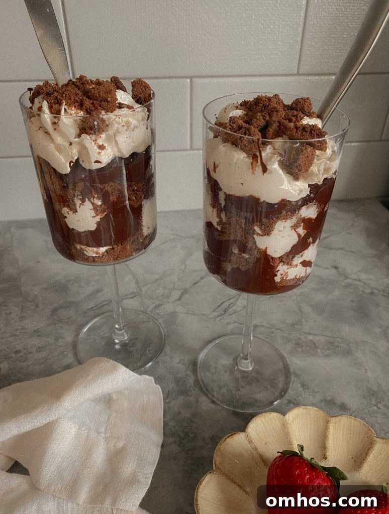 Creamy Vegan and Paleo Chocolate Pudding Recipe 3 Vegan Chocolate Pudding in a Wine glass on a granite counter with coconut cool whip and crushed chocolate cookie crumble