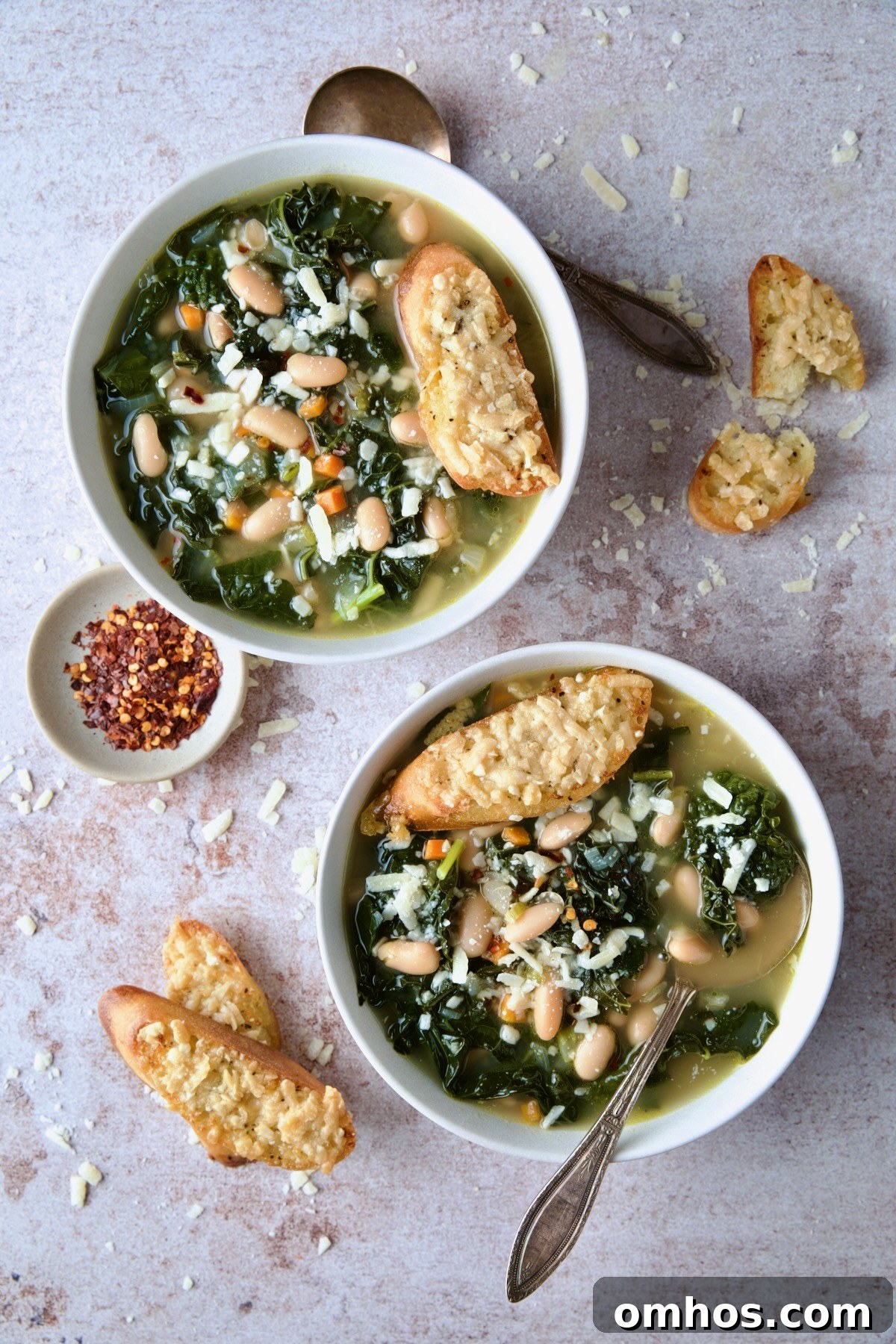 Two bowls of White Bean Kale Soup with Parmesan Toast.