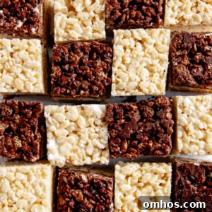 Chocolate-Vanilla Layered Rice Krispie Treats arranged like a checkered board pattern on white parchment paper.