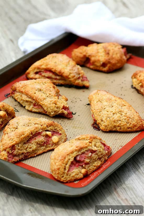 Roasted Rhubarb Scones with White Chocolate on a baking sheet.