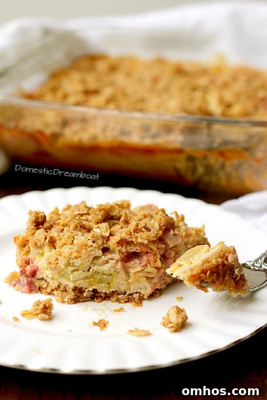 Slice of rhubarb crisp on a white plate