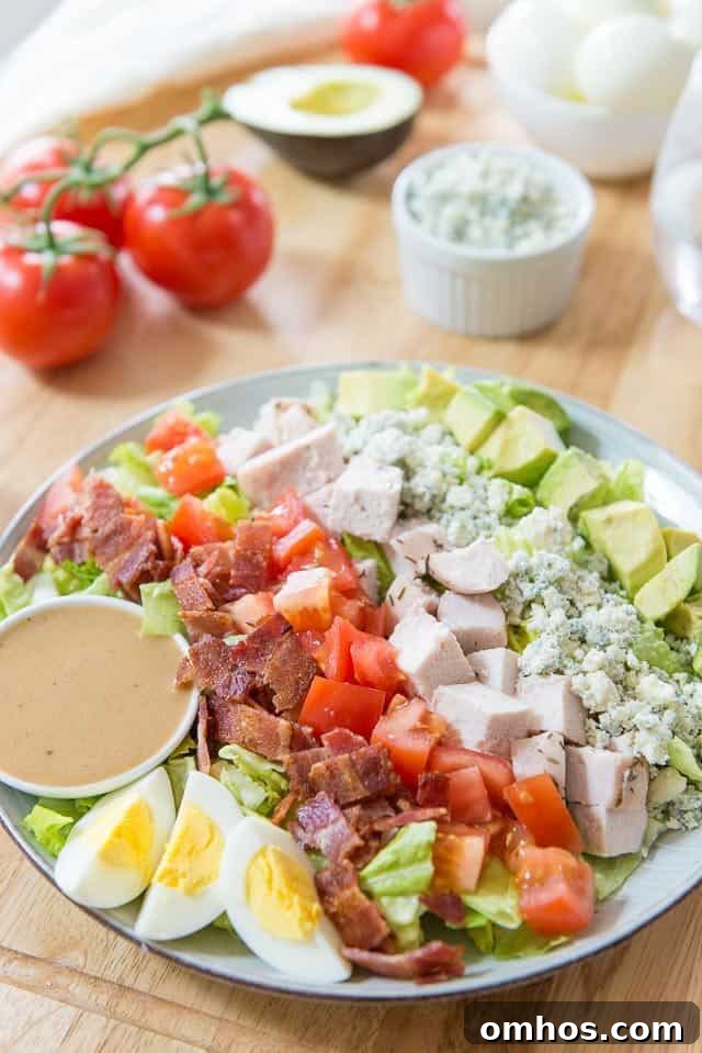 Classic Cobb Salad with Bacon, Avocado and Blue Cheese 2 Cobb Salad - With Avocado Chunks, Blue Cheese, Chicken Breast, Tomato, Bacon, and Eggs