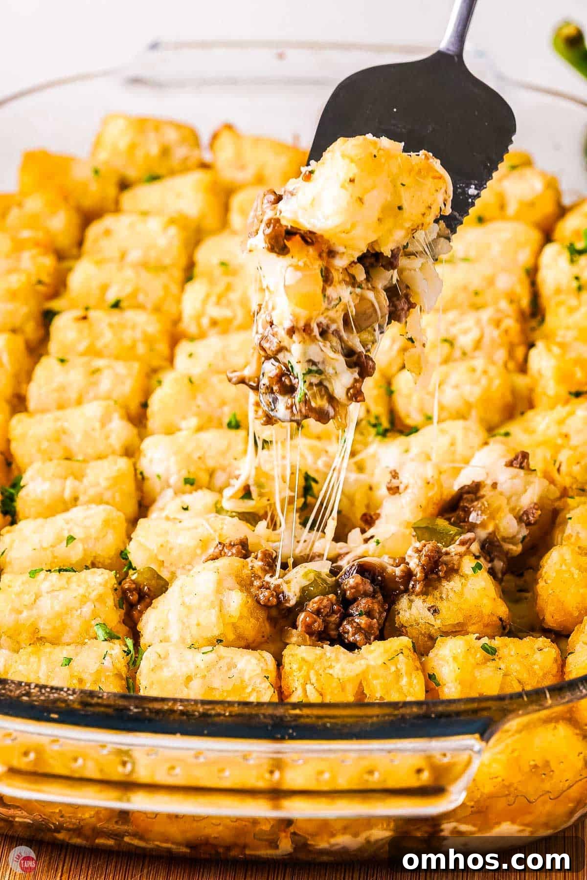 closeup of philly cheesesteak tater tot casserole with melted cheese