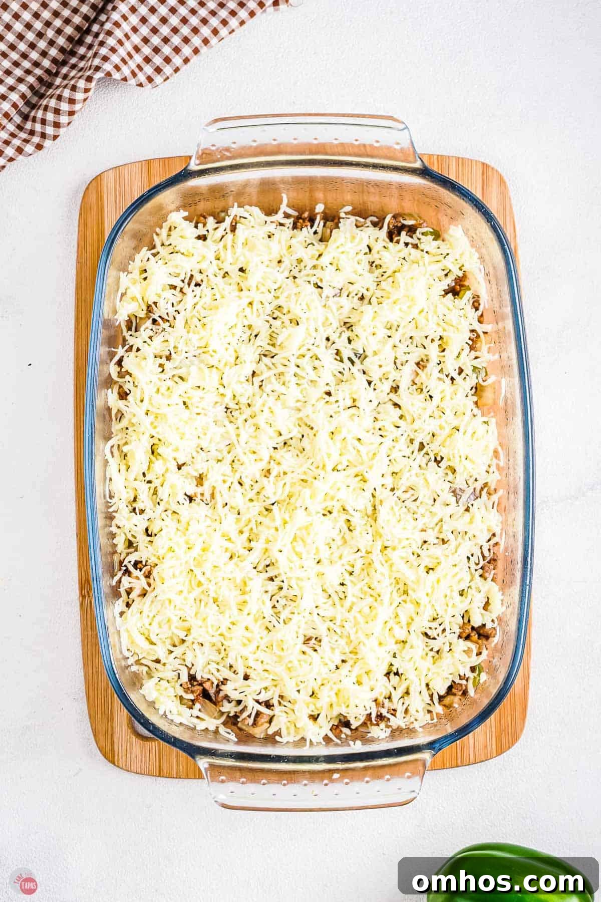 casserole dish with shredded cheese
