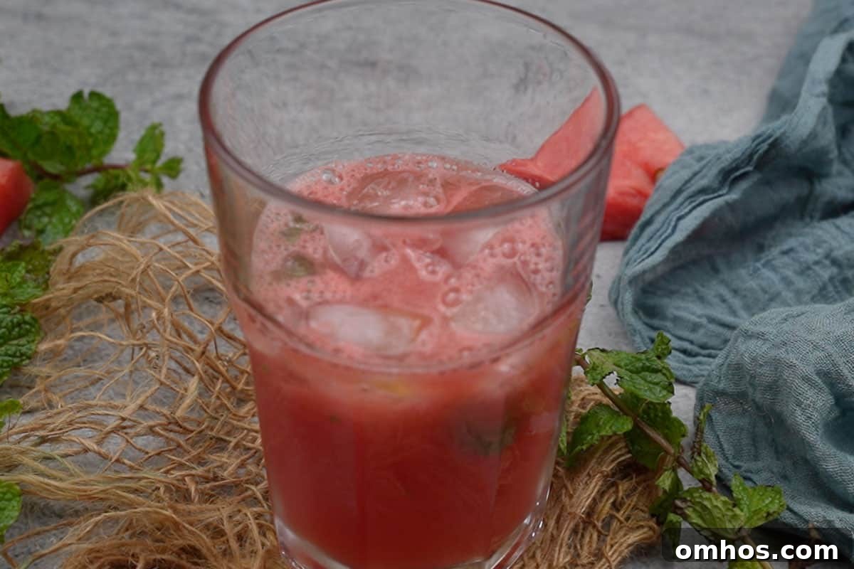 Refreshing Watermelon Mint Mojito Cocktail 11 Glass filled half with watermelon mixture.