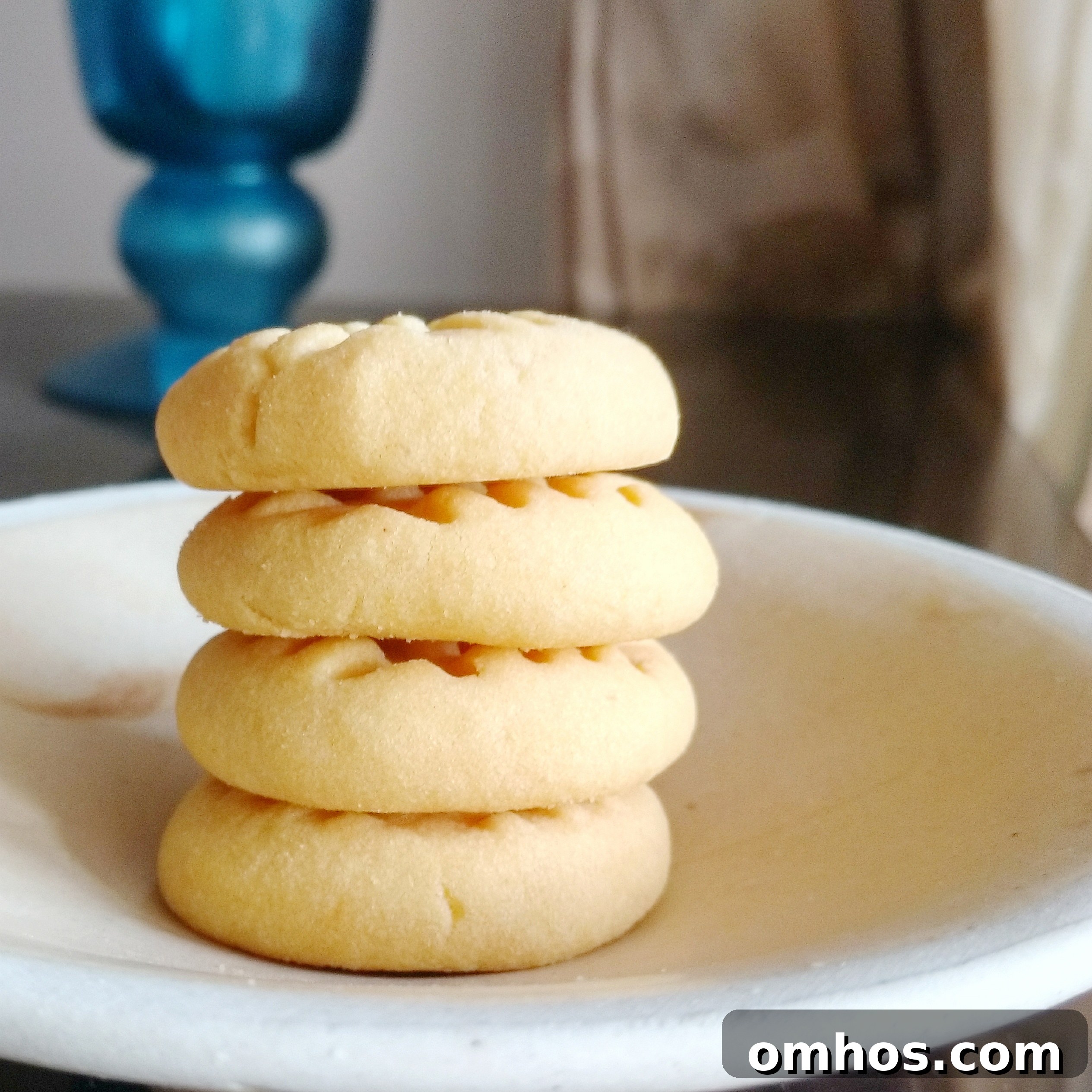 Four ingredient custard cookies cooling on a plate