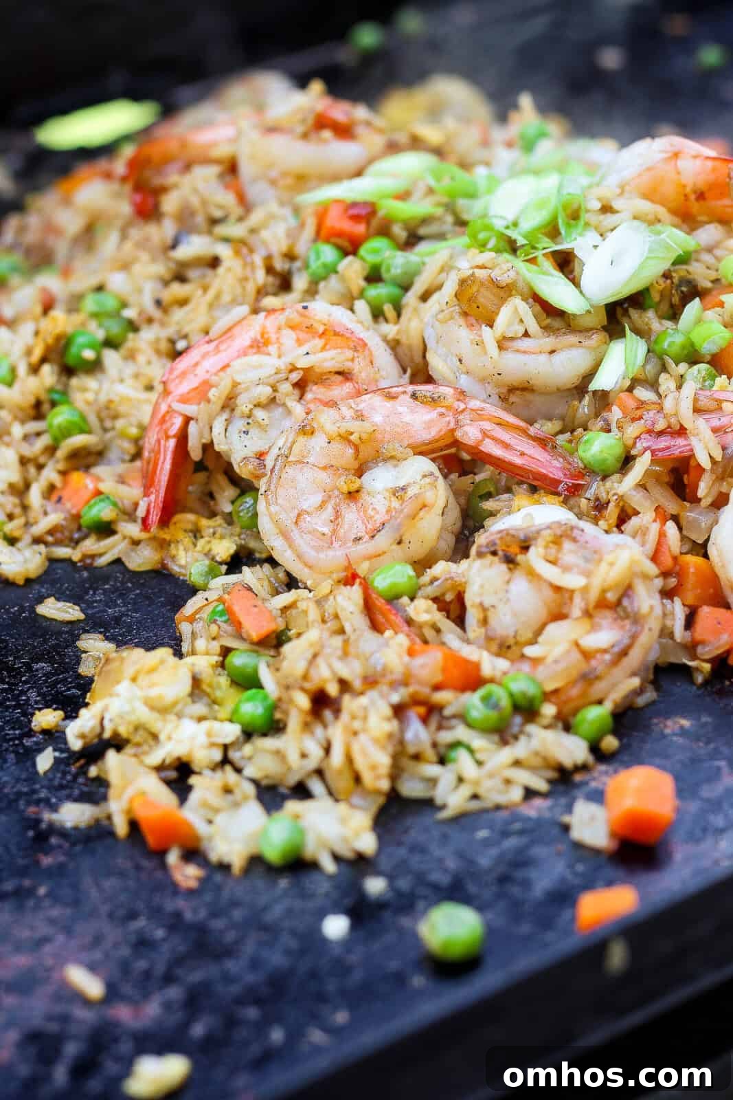 Blackstone shrimp fried rice cooking on the hot cooktop.
