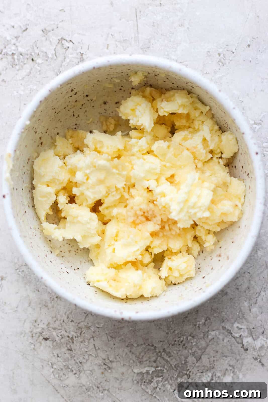 Garlic butter in a small bowl before being used in a Blackstone shrimp fried rice.