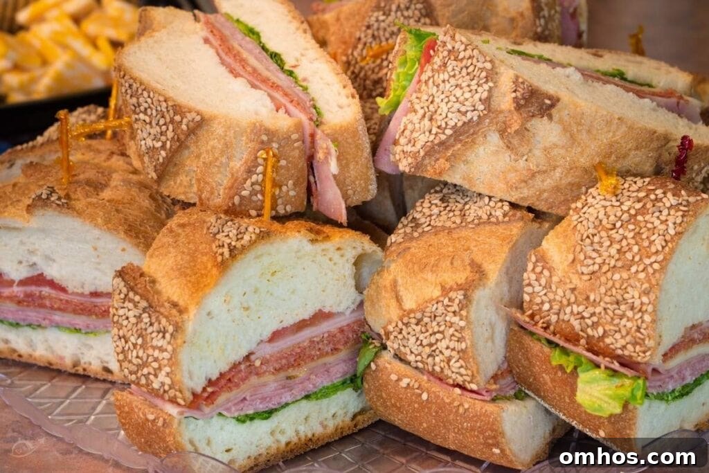 Small sub sandwiches on a clear plate.