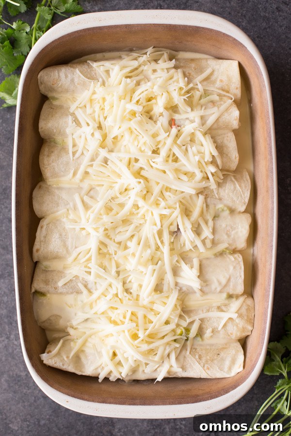 Hatch Green Chile Chicken Enchiladas in a baking dish before baking. 