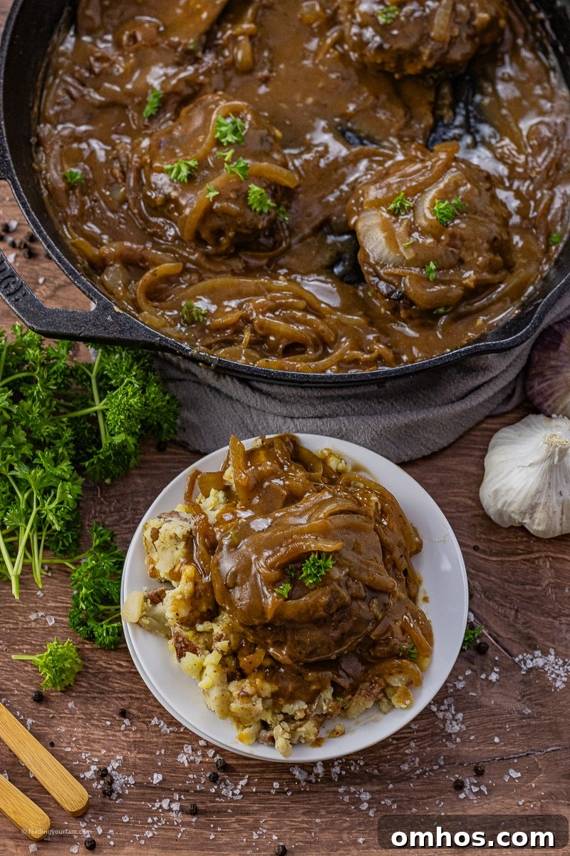 hamburger steaks topped with onion gravy over mashed potatoes
