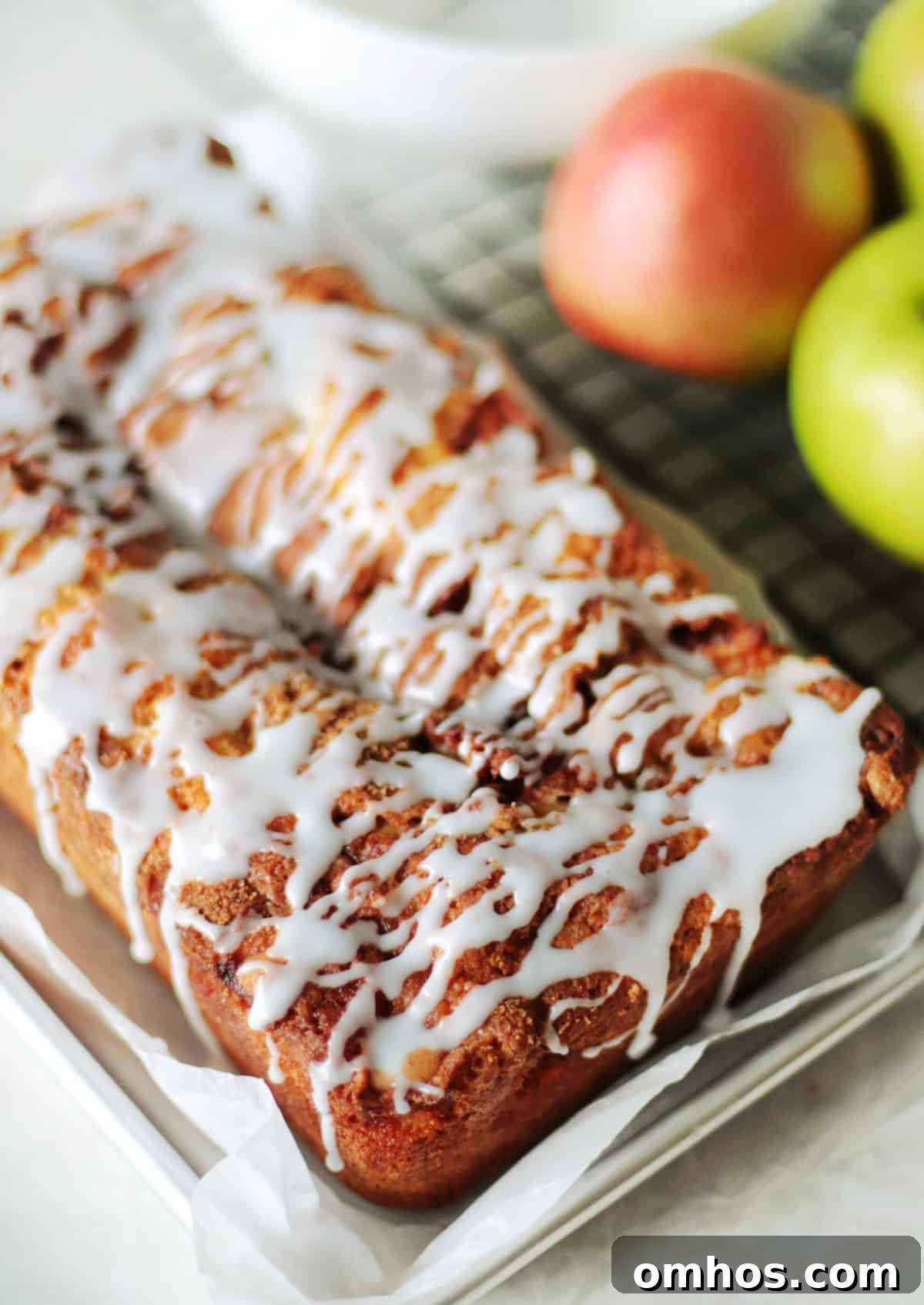 Homemade Apple Fritter Bread with Cinnamon Glaze 2 Loaf of apple fritter bread on baking tray.