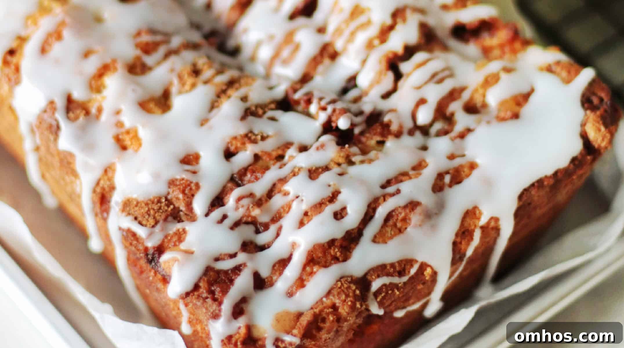 Homemade Apple Fritter Bread with Cinnamon Glaze 11 Apple fritter loaf drizzled in glaze.